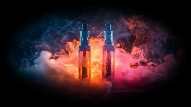 Two vapes in colored smoke