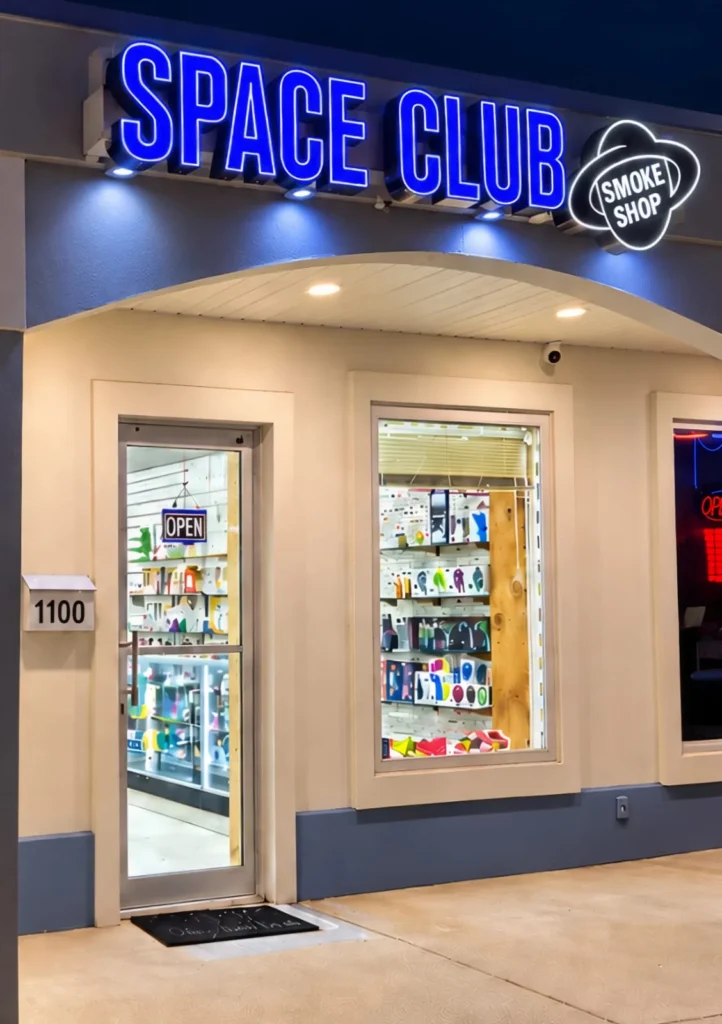Space Club storefront with the blue sign at night